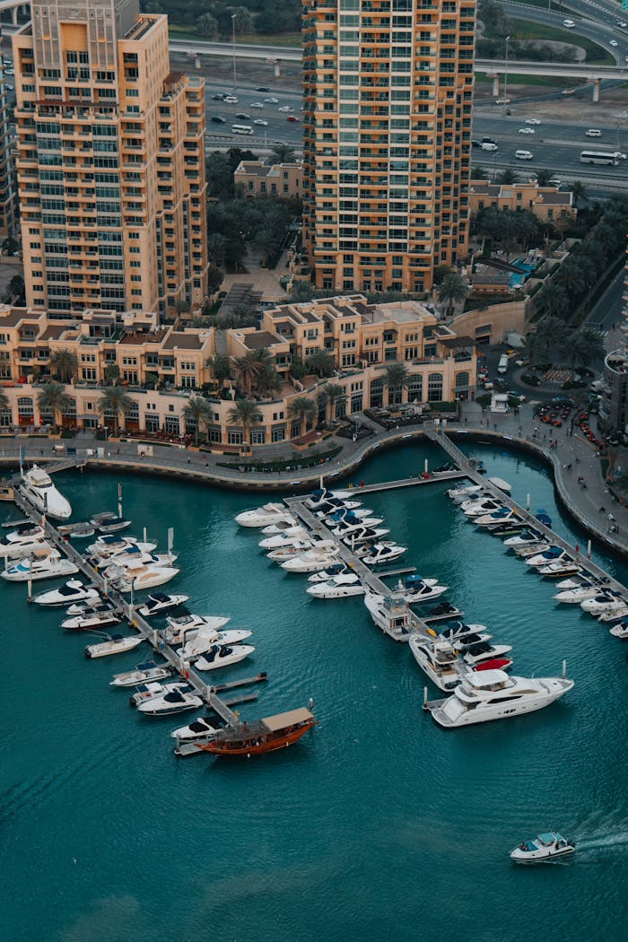 Stunning aerial capture of a luxury marina with yachts and skyscrapers in the background.