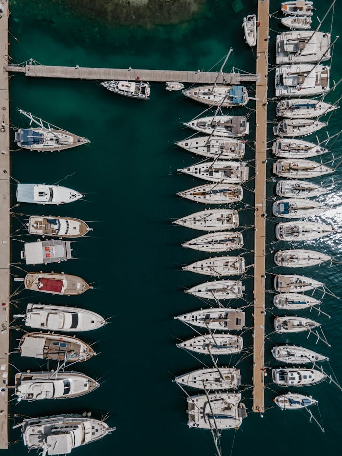 Drone shot capturing yachts docked at a marina in Il-Kalkara, Malta, showcasing a serene harbor scene.
